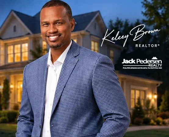 Kelcey Brown in the blue checked blazer from the approved website rendering, against a house at dusk